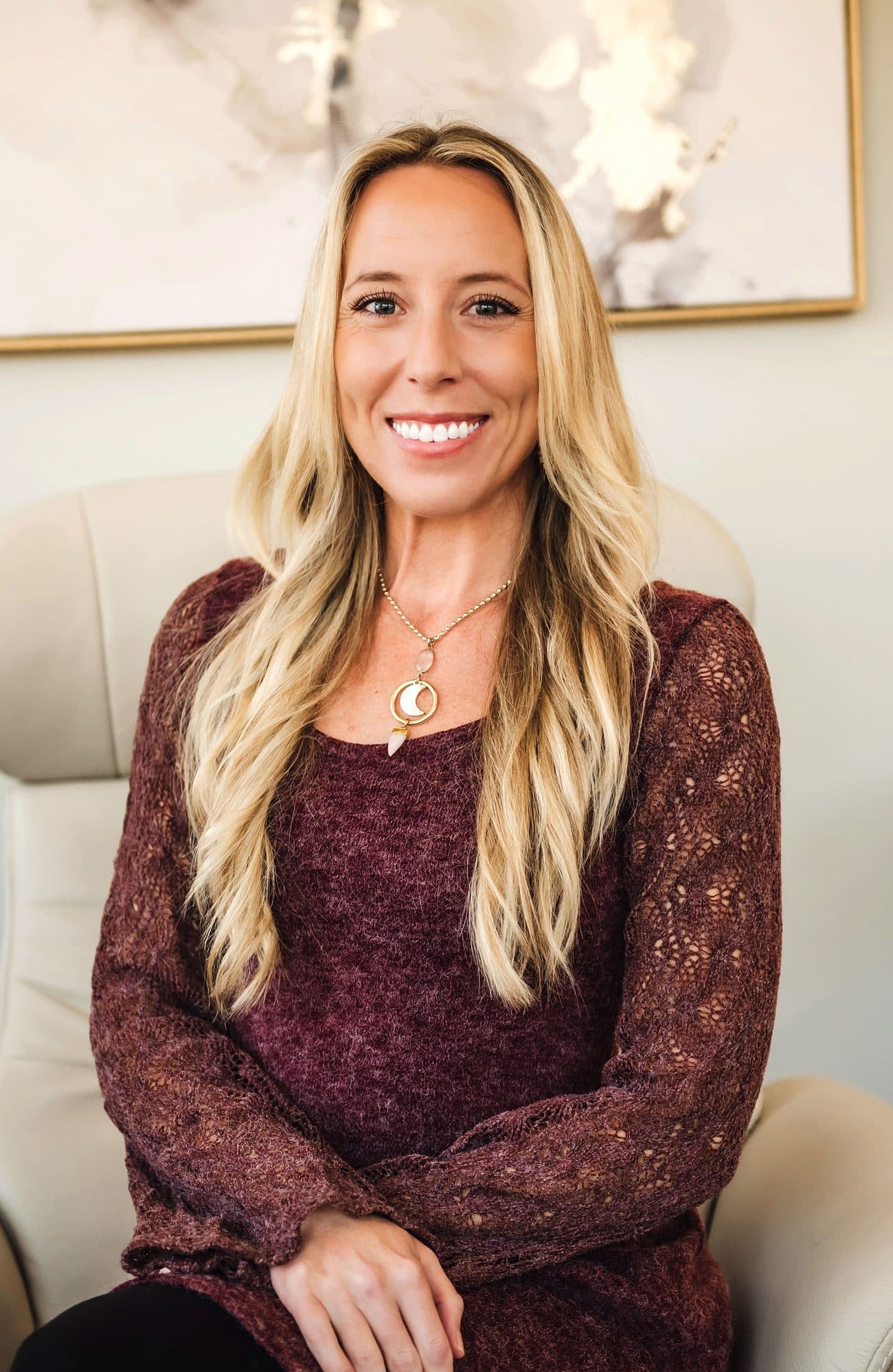 Ellie Wheeler, Psy.D., smiling in her San Diego therapy office